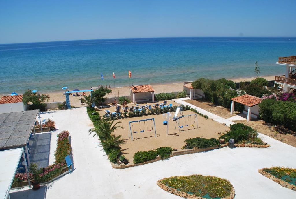a view of the beach from the balcony of a resort at Residence Le 4 Stagioni in Menfi