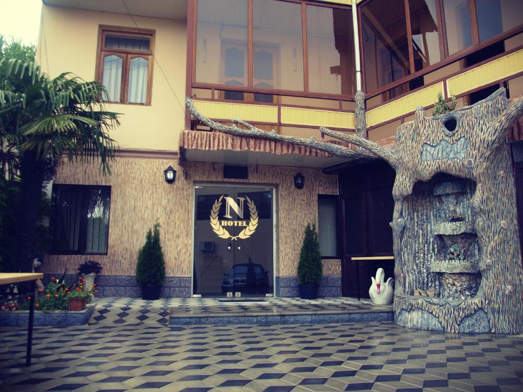 a front door of a building with a sign on it at Hotel Nikala in Tskaltubo