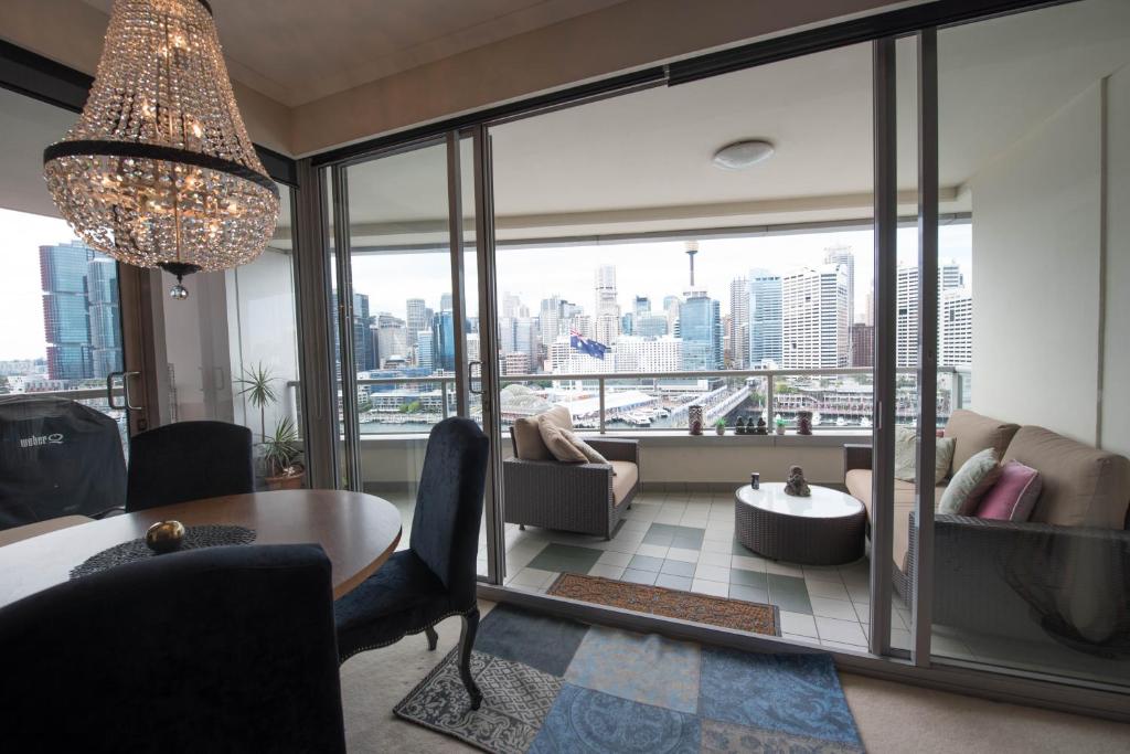 a living room with a view of a city at Darling Harbour Getaway in Sydney