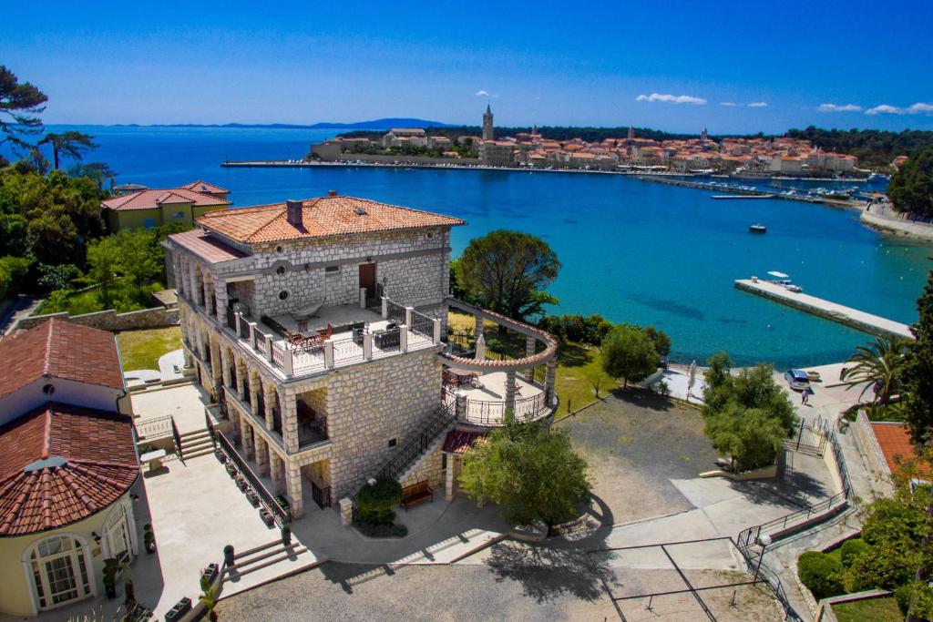 an aerial view of a building next to a body of water at Villas Arbia - Margita Beach hotel in Rab