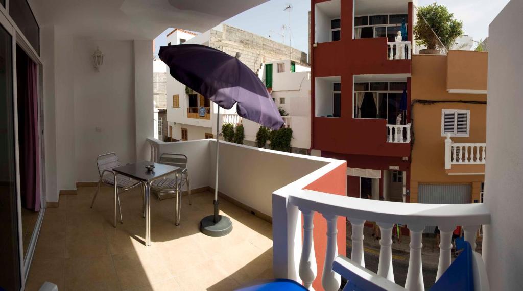 - Balcón con mesa y sombrilla en Casa Atlantica en Alcalá