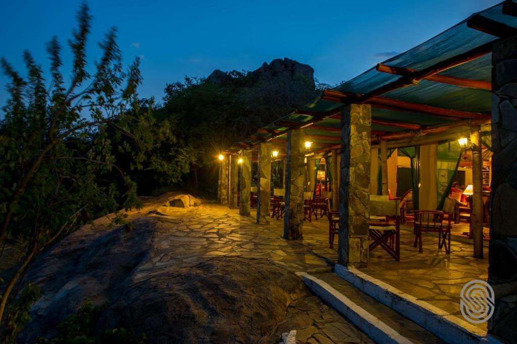 a patio of a house at night at Mbuzi Mawe Serena Camp in Serengeti