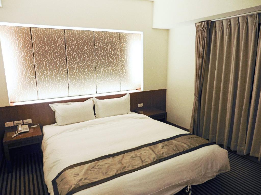 Postel nebo postele na pokoji v ubytování Tapeng Bay Holiday Hotel