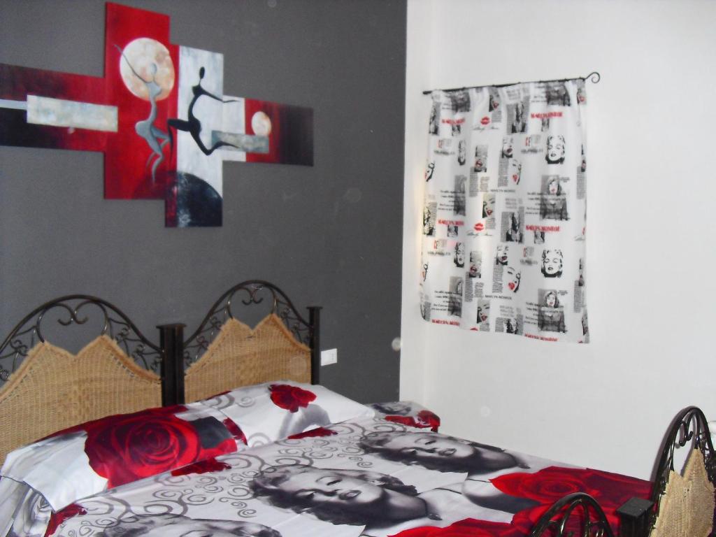 a bedroom with a bed with a poster on the wall at APPARTAMENTO Exclusive in Marsala