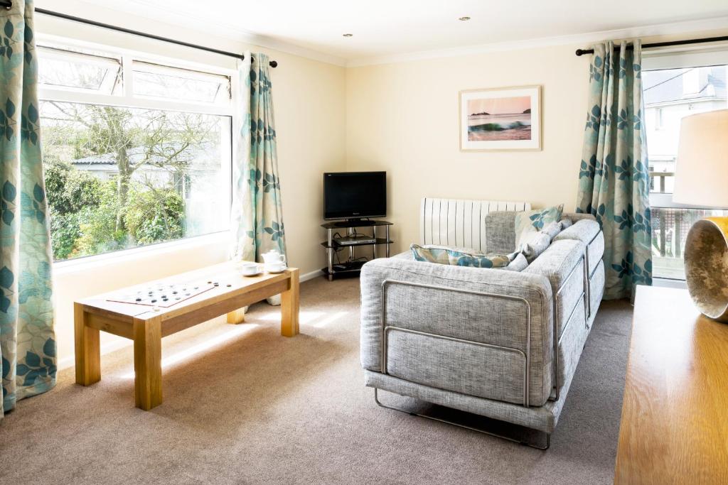 a living room with a couch and a table at Gwithian Holidays in Hayle