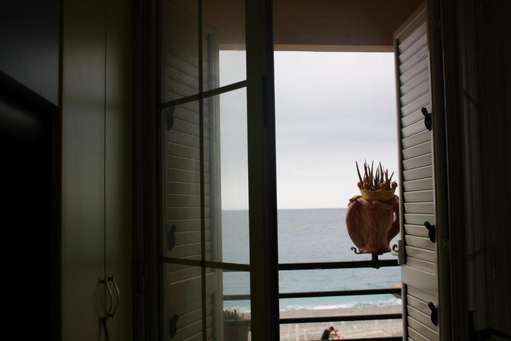 a window view of the ocean from a house at Patrancarro Home in Letojanni