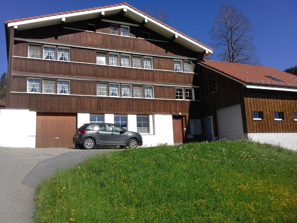 a car parked in front of a house at Säntisblick in Urnäsch