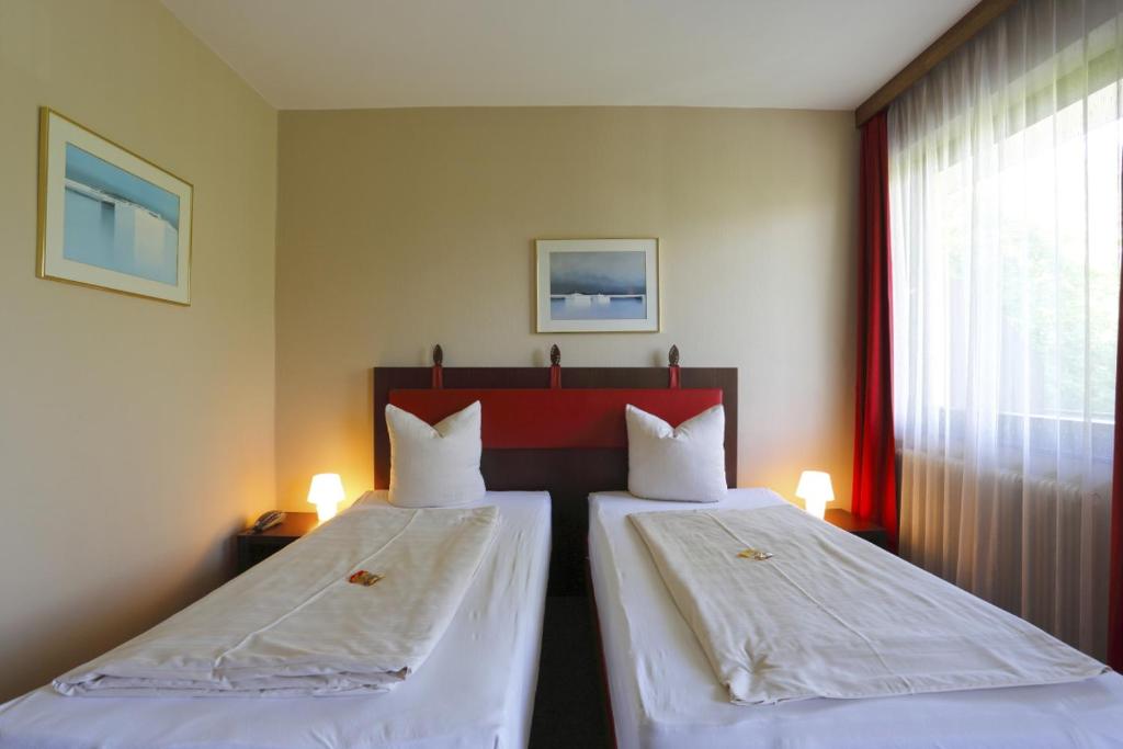 Postel nebo postele na pokoji v ubytování Alpen.Adria.Stadthotel