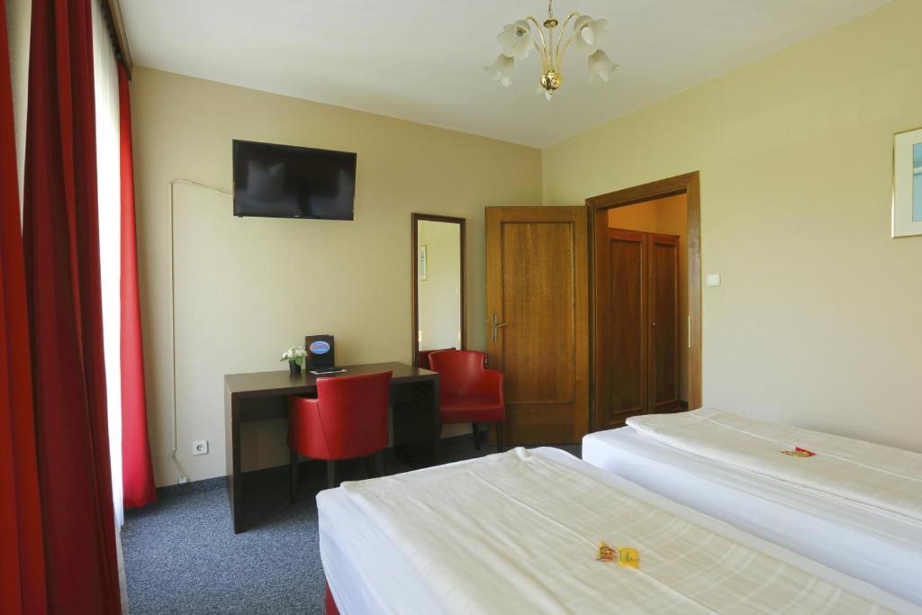 Postel nebo postele na pokoji v ubytování Alpen.Adria.Stadthotel