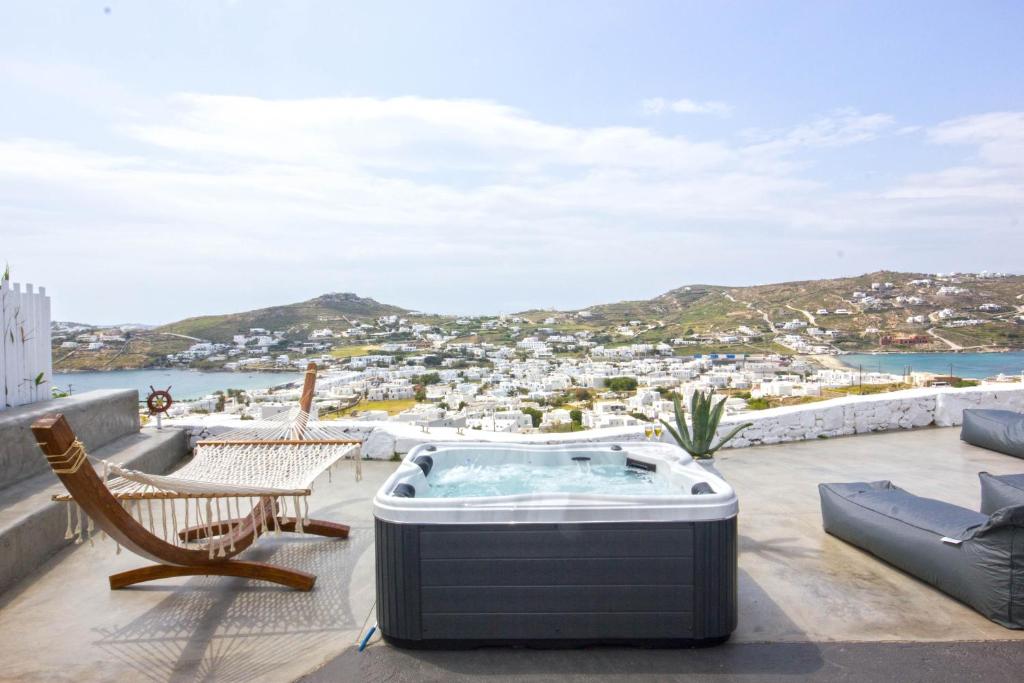 a hot tub on the roof of a house at Anixi Lounge Suites - Adults Only in Ornos