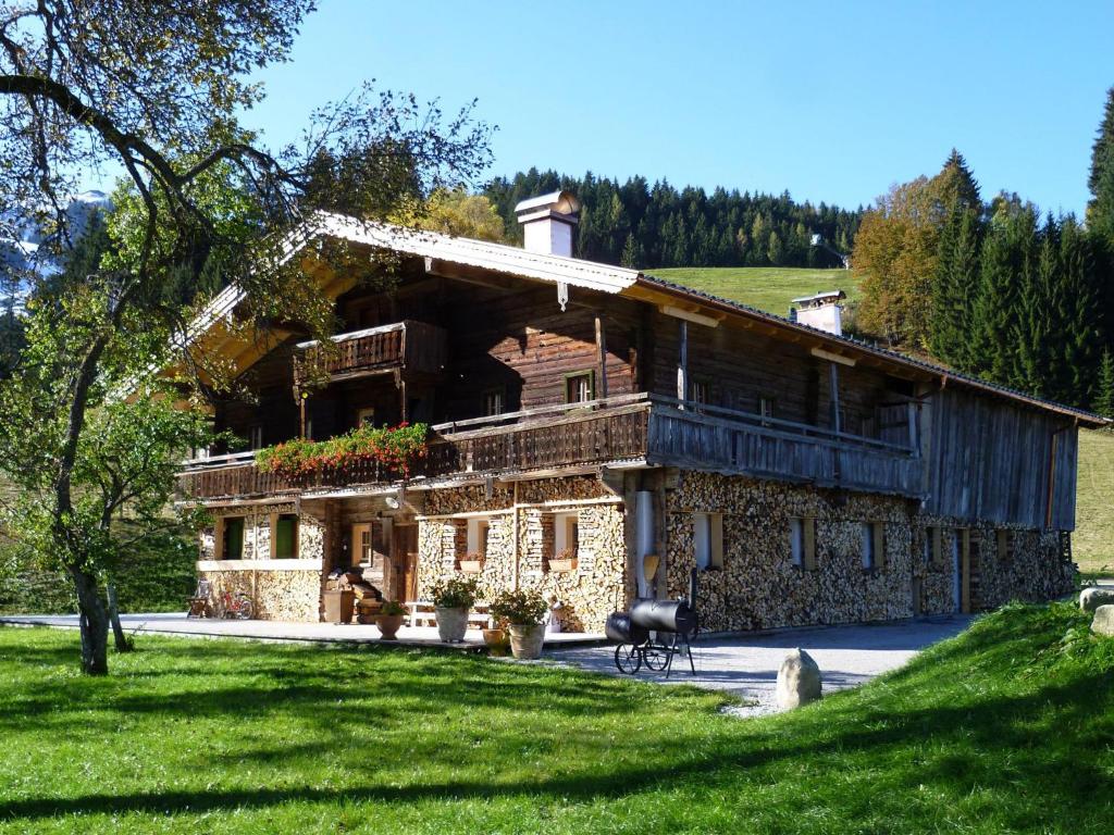 a large stone house in the middle of a field at Noba Hof in Söll