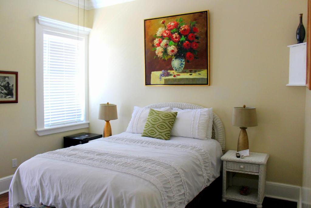 a bedroom with a bed with a painting on the wall at The Casablanca Hotel in Key West