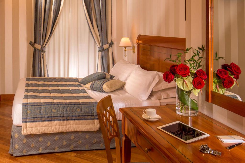Postel nebo postele na pokoji v ubytování Albergo Ottocento