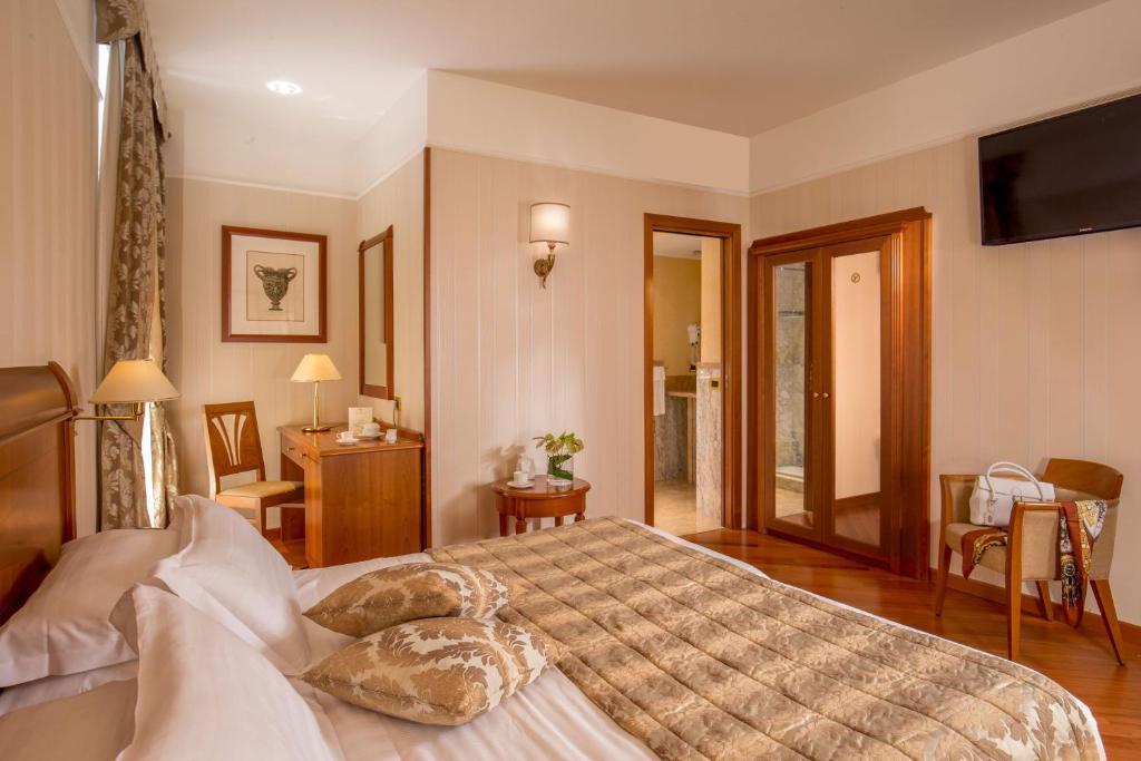 Postel nebo postele na pokoji v ubytování Albergo Ottocento