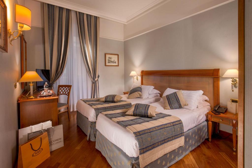 Postel nebo postele na pokoji v ubytování Albergo Ottocento