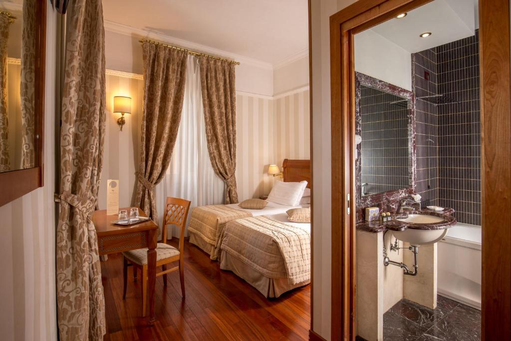 Postel nebo postele na pokoji v ubytování Albergo Ottocento