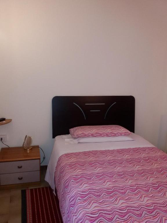 Postel nebo postele na pokoji v ubytování Albergo Luca