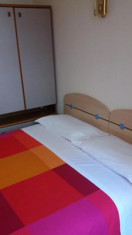 Postel nebo postele na pokoji v ubytování Albergo Luca