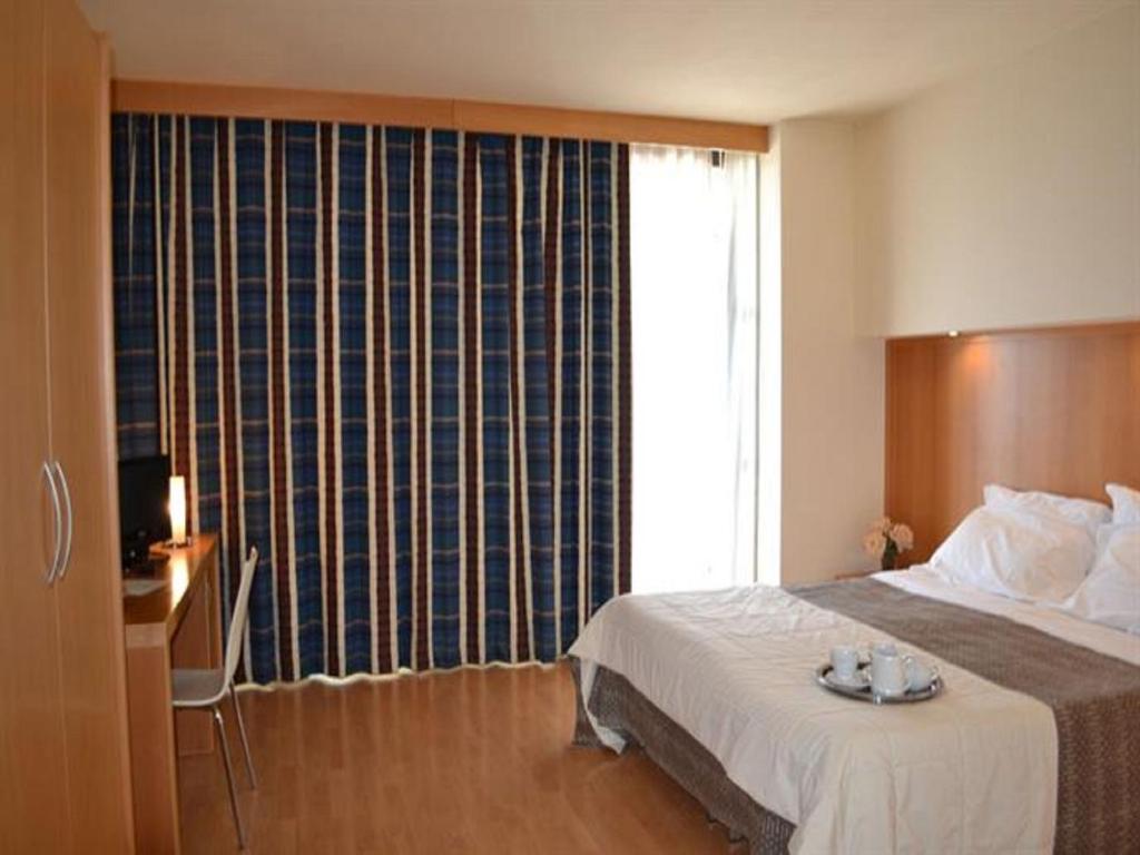 Postel nebo postele na pokoji v ubytování Hotel Ristorante Trendy