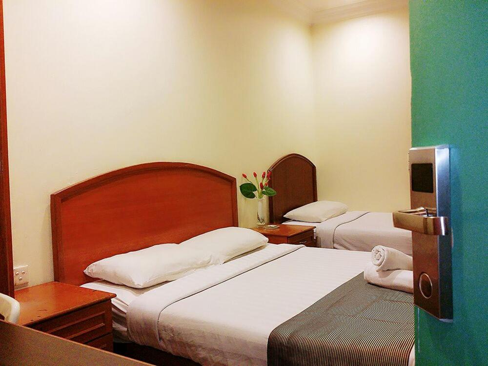 Postel nebo postele na pokoji v ubytování SkyGlobal Hotel