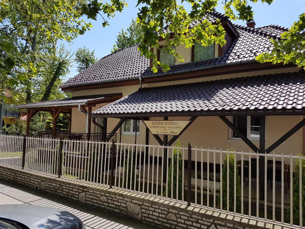 a house with a fence in front of it at Táncsics Vendégház in Siófok