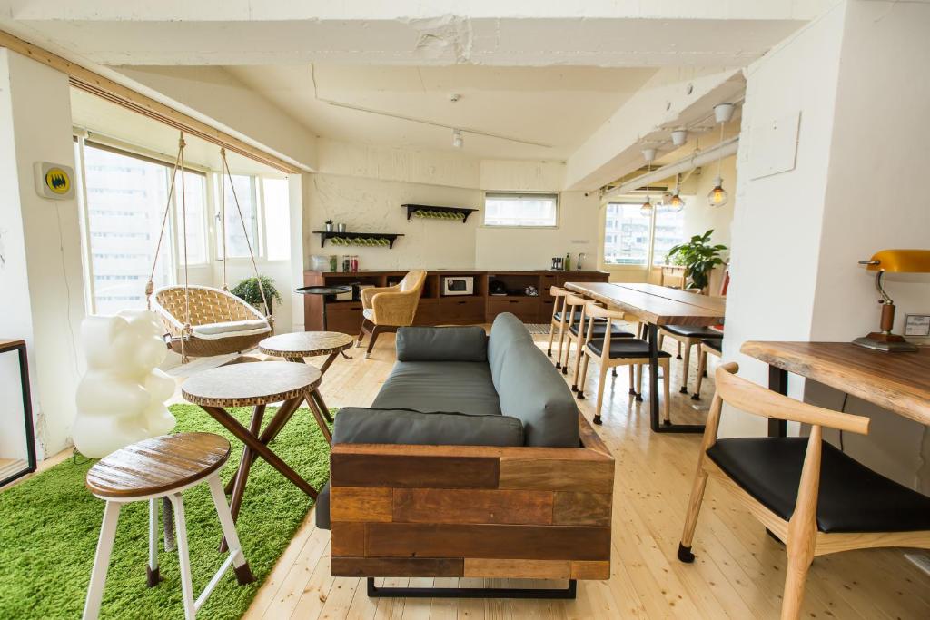 a living room with a couch and a table at Mr. Lobster’s Secret Den design hostel in Taipei
