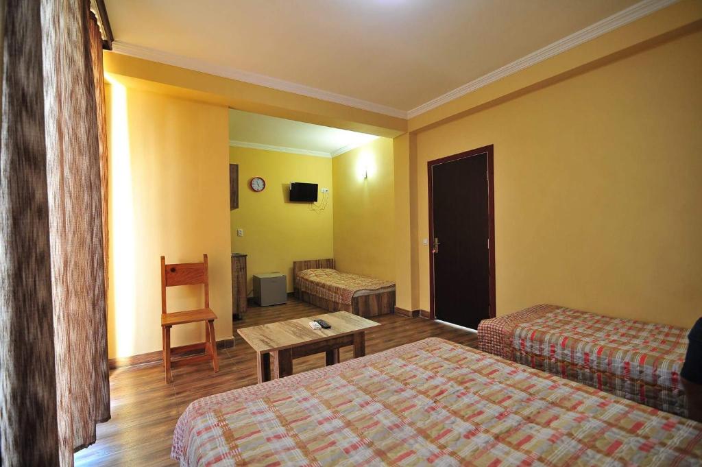 Postel nebo postele na pokoji v ubytování Magnetic Sand Hotel