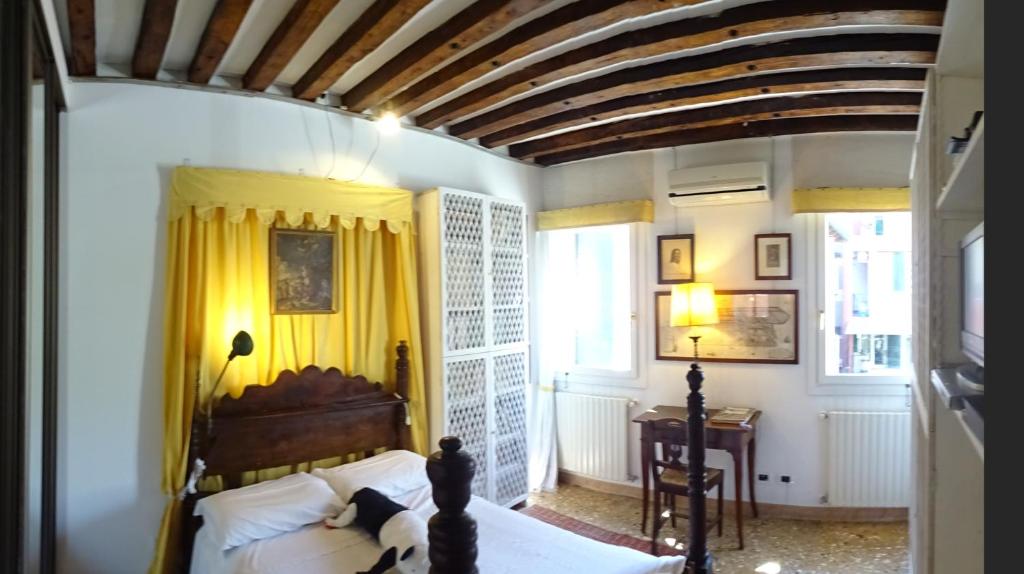 a bedroom with a bed and a wooden ceiling at Artist House in Venice