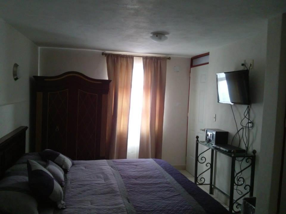 Postel nebo postele na pokoji v ubytování Hotel El Beso De Calixto