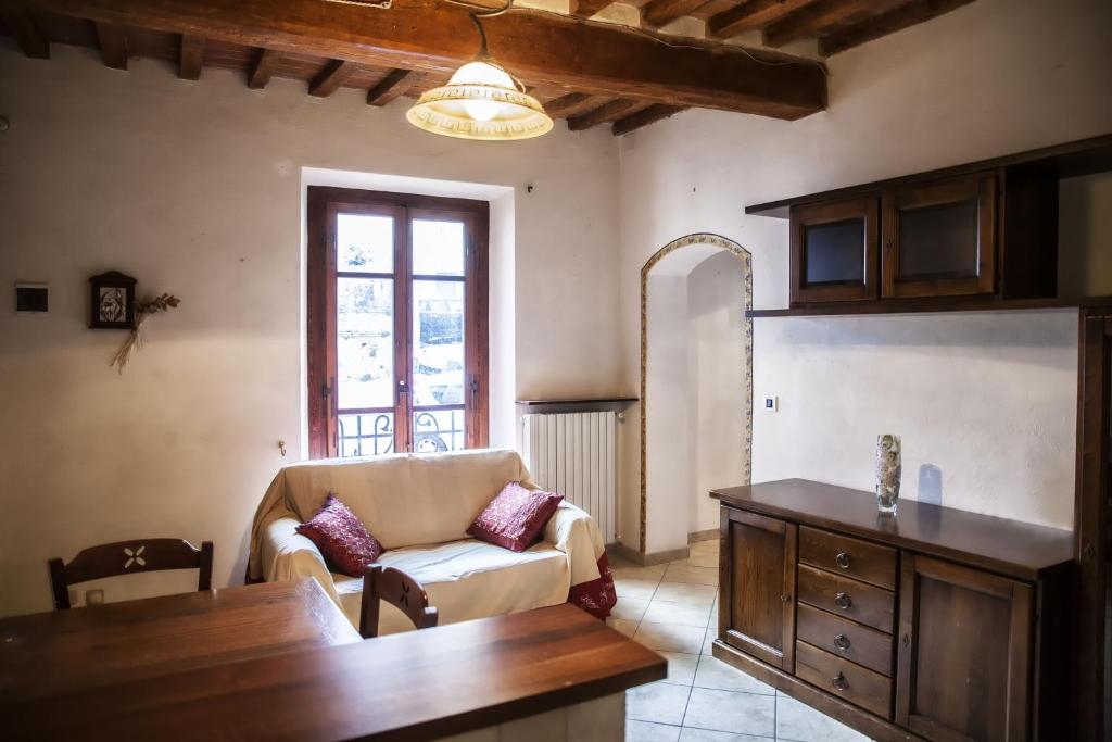 uma sala de estar com um sofá e uma mesa em Il Castello em Bucine