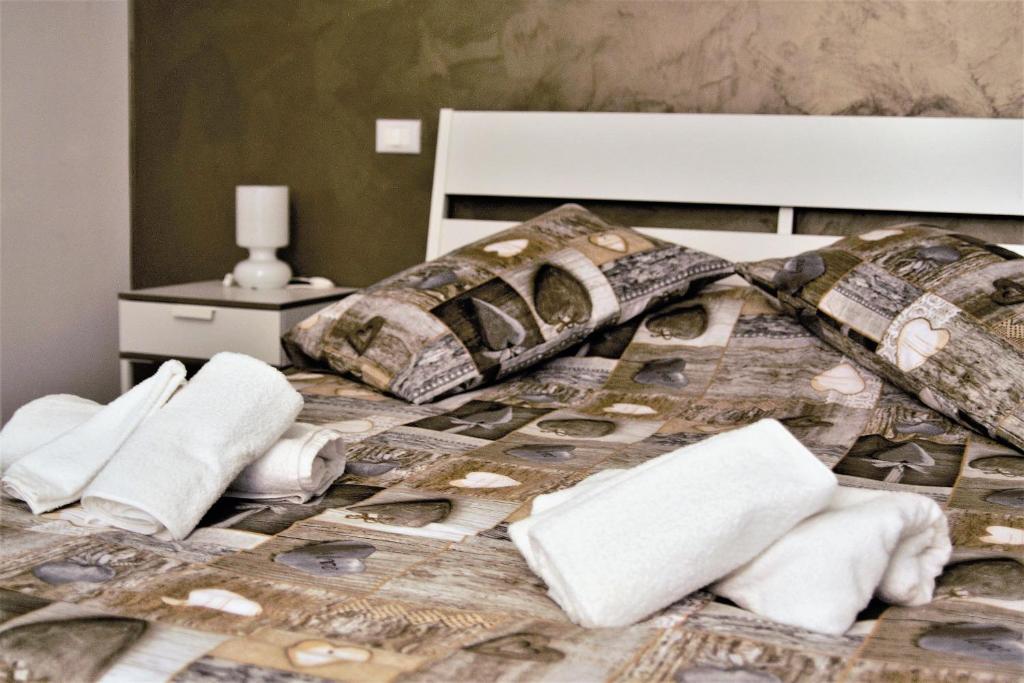 łóżko z ręcznikami i poduszkami w obiekcie Casa Silve w mieście La Spezia