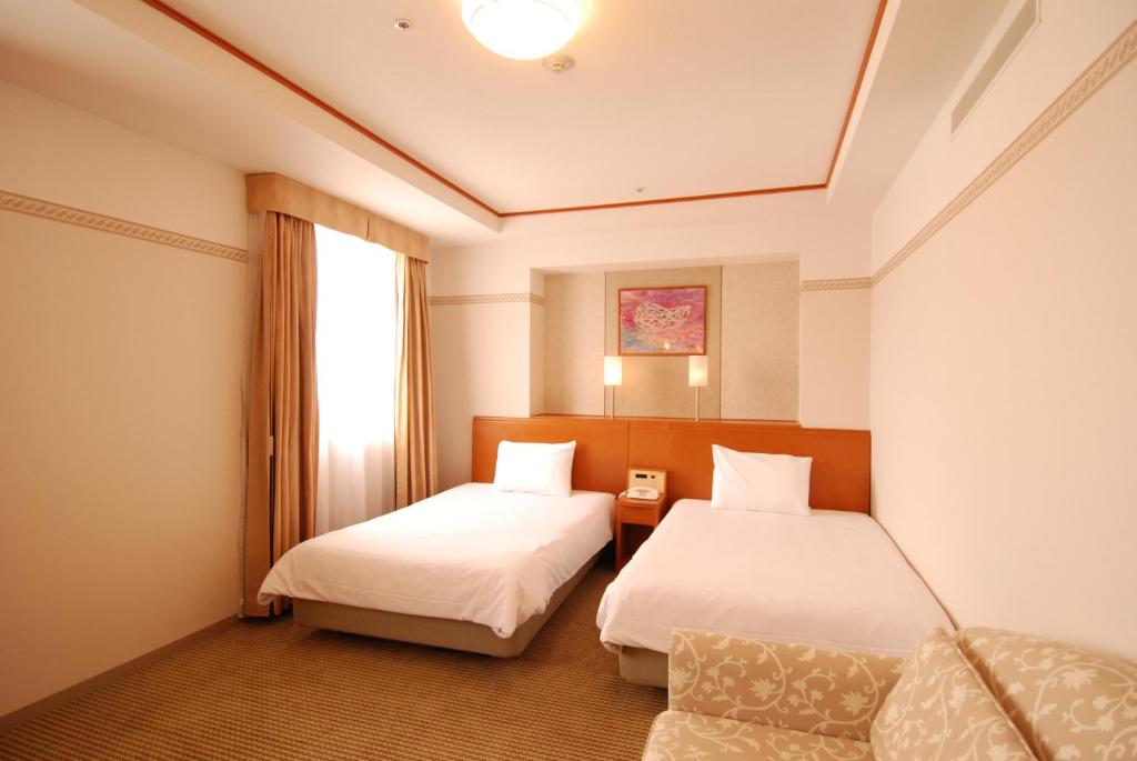 Postel nebo postele na pokoji v ubytování Hotel Tetora Otsu Kyoto