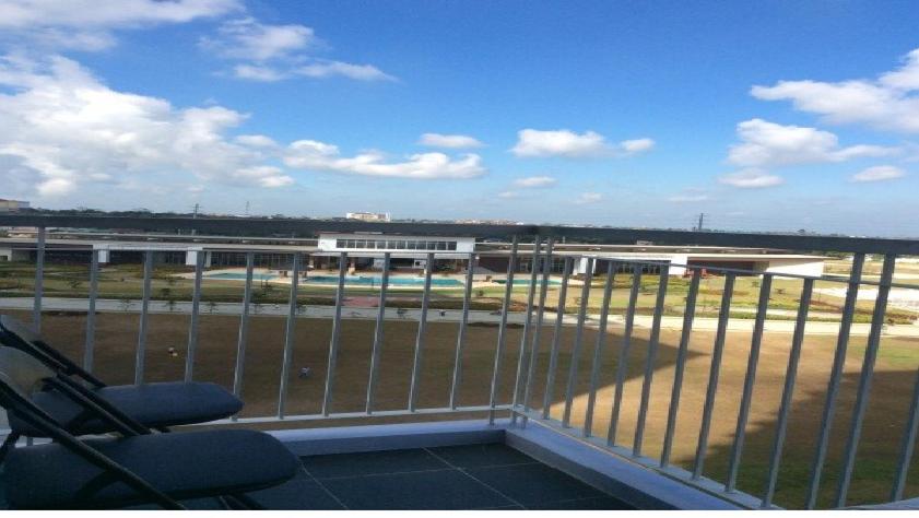 a balcony with a view of an airport with a train at Tagaytay Winds in Tagaytay