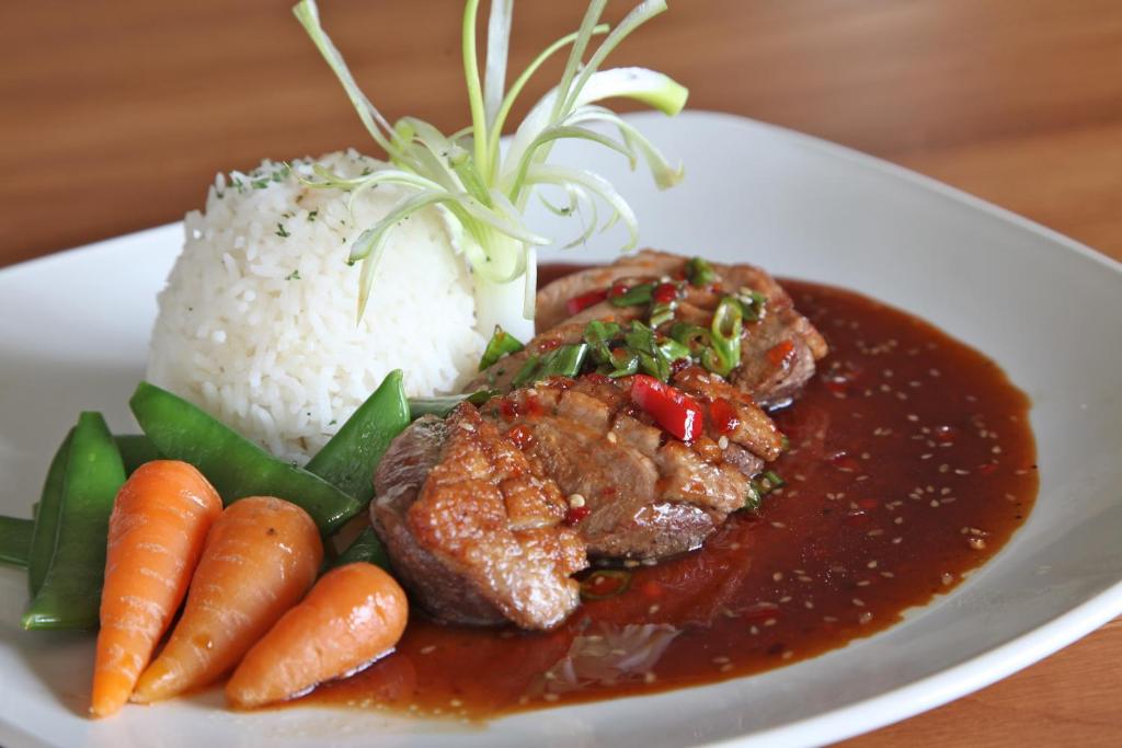 a plate of food with meat and rice and carrots at Bowood Park Hotel in Camelford