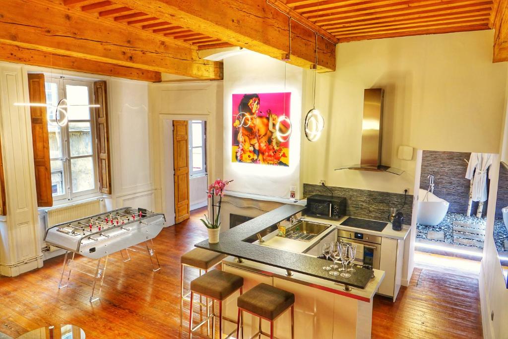 a kitchen with a sink and a stove top oven at le XVI de la Rose in Lyon