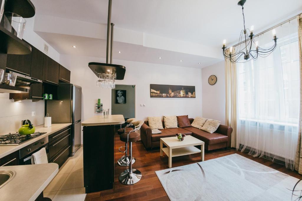 a kitchen and living room with a couch and a table at Hieronim - by the Vistula River in Krakow