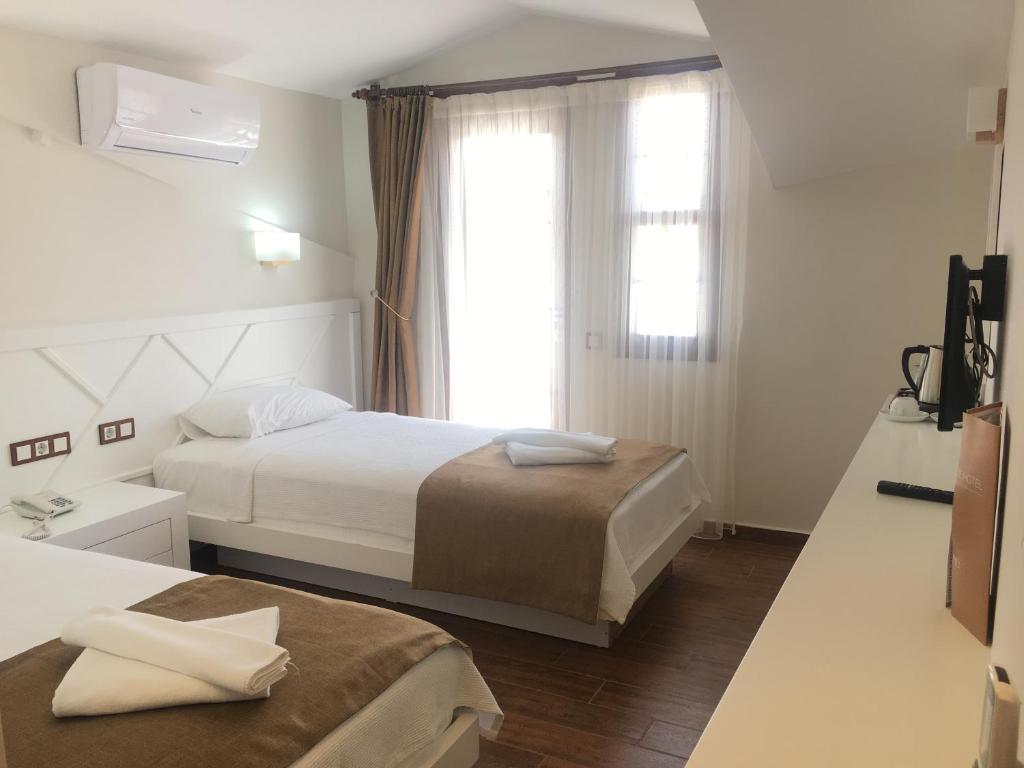 A bed or beds in a room at Elegance Hotel Kemer