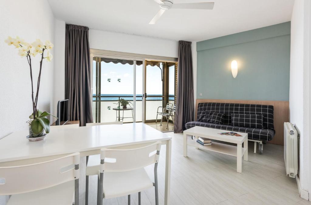 a living room with a table and a couch at Flats Friends Atlantida in Benidorm