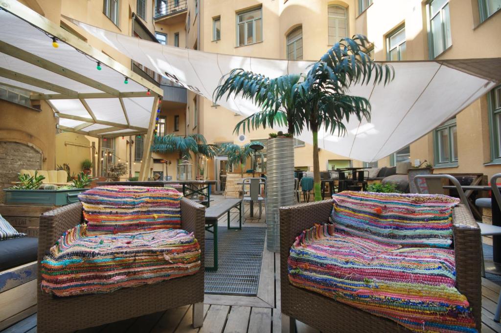 a pair of chairs with blankets on them on a patio at City Backpackers Hostel in Stockholm