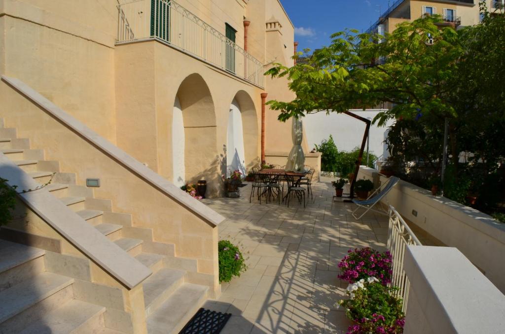 an outdoor patio with stairs and a table and chairs at Il Trifoglio in Matera