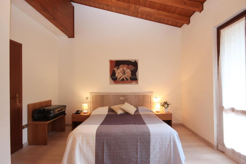 Postel nebo postele na pokoji v ubytování Hotel Colomber