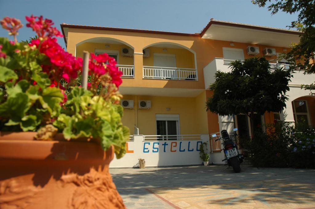 a house with a motorcycle parked in front of it at Estelle Hotel in Gerakini