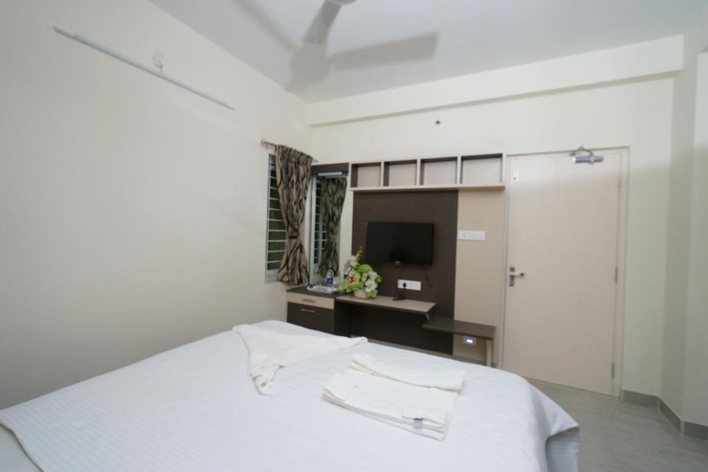 Postel nebo postele na pokoji v ubytování Krishna Vibe Service Apartment