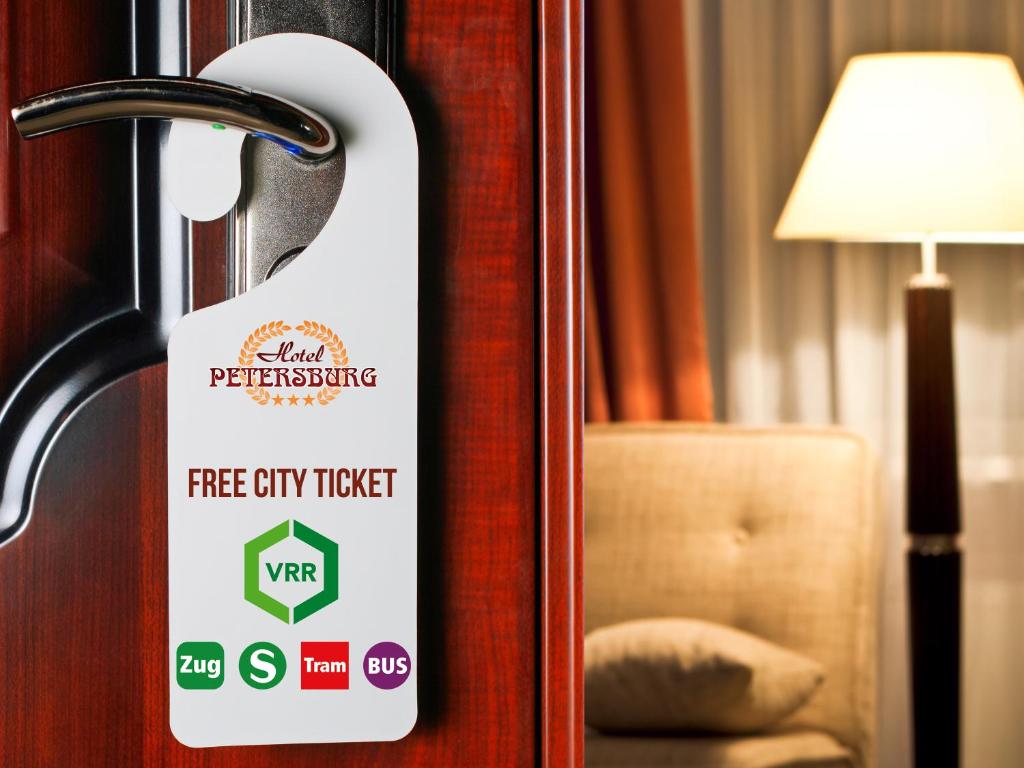 a sign on a door that says free city ticket at Hotel Petersburg Superior in Düsseldorf