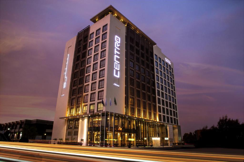 a tall building with a sign on it at night at Centro Shaheen Jeddah by Rotana in Jeddah