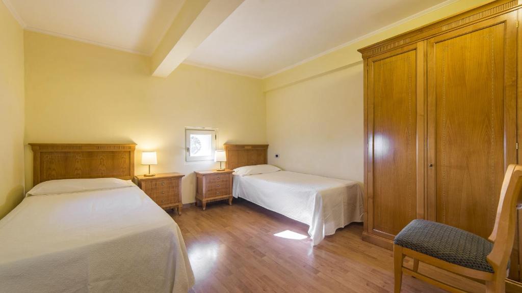 Postel nebo postele na pokoji v ubytování Hotel Ville Bianchi