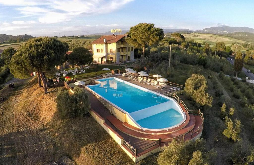 an aerial view of a house with a swimming pool at Tenuta La Lupa in Castellina Marittima