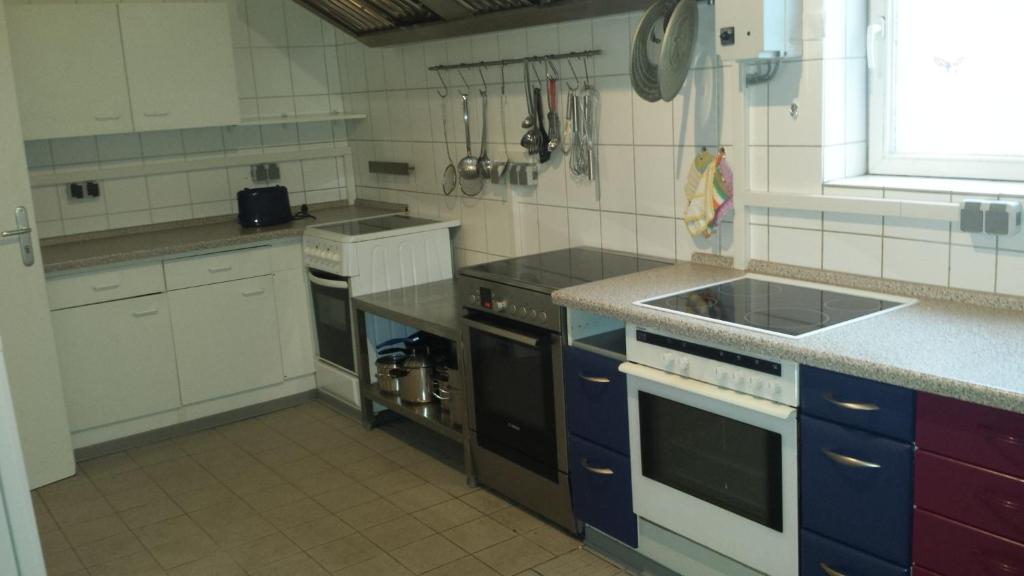 eine Küche mit einer Spüle und einem Herd Top-Backofen in der Unterkunft Gaestehaus Willis -Monteurzimmervermietung- in Vienenburg