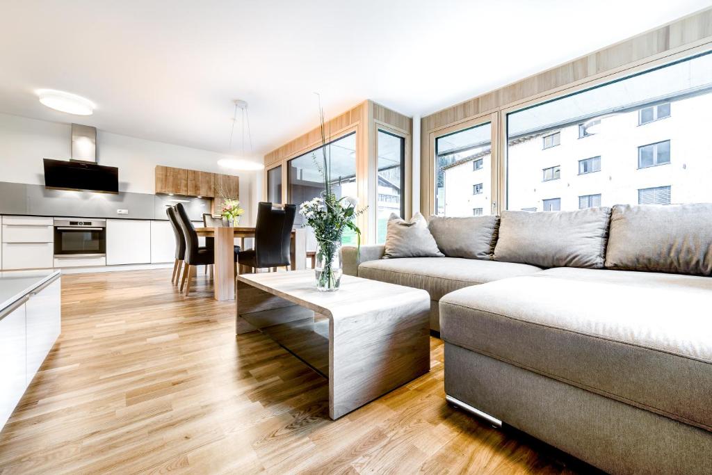 a living room with a couch and a table at Gartenappartment de Luxe by A-Appartments in Brand