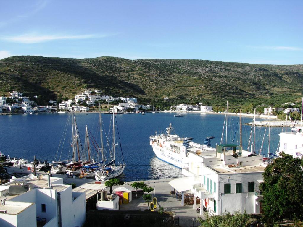 a group of boats are docked in a harbor at Anna Studios in Katapola